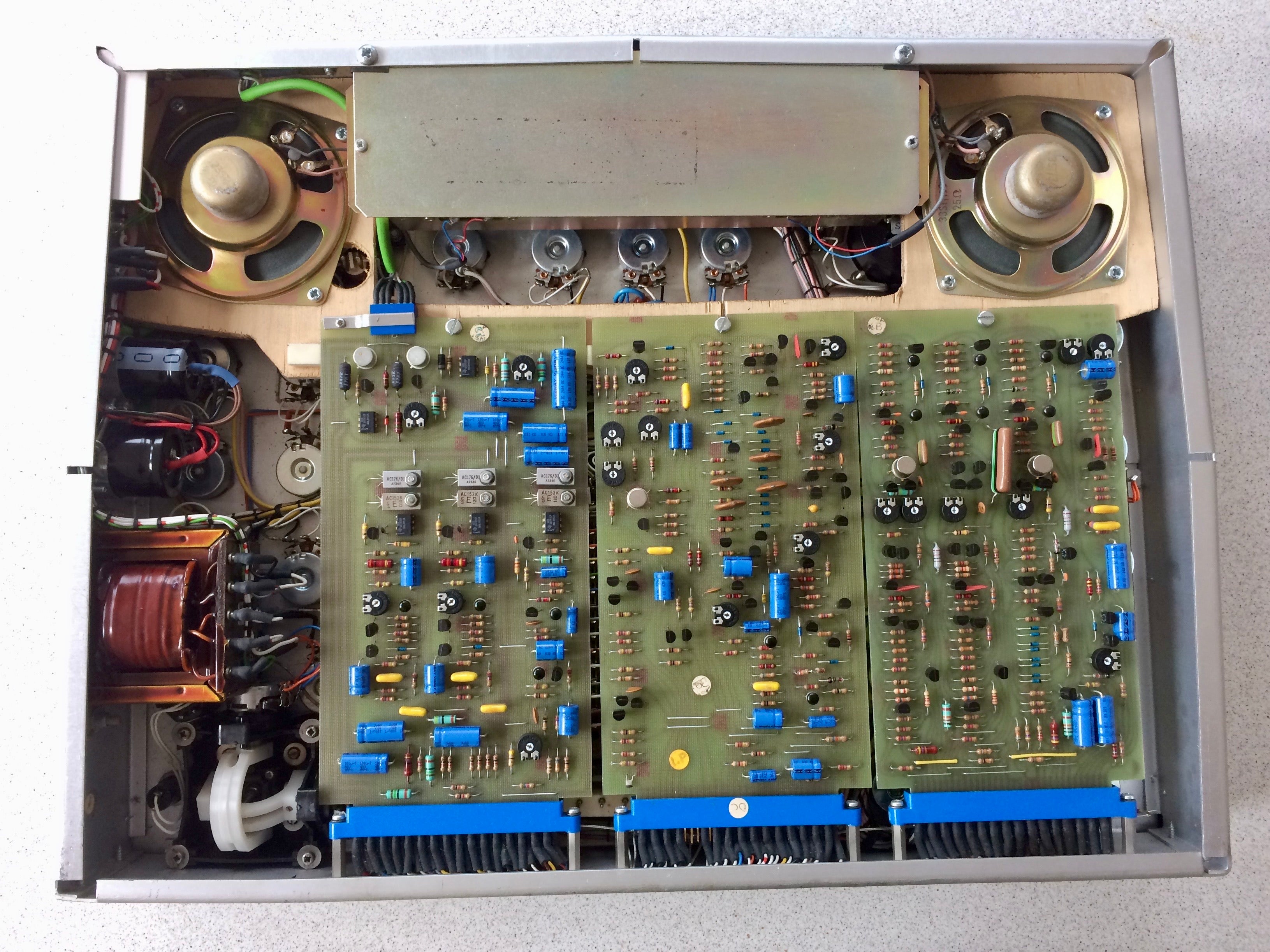 Electronic circuit board with various components on a metallic frame.