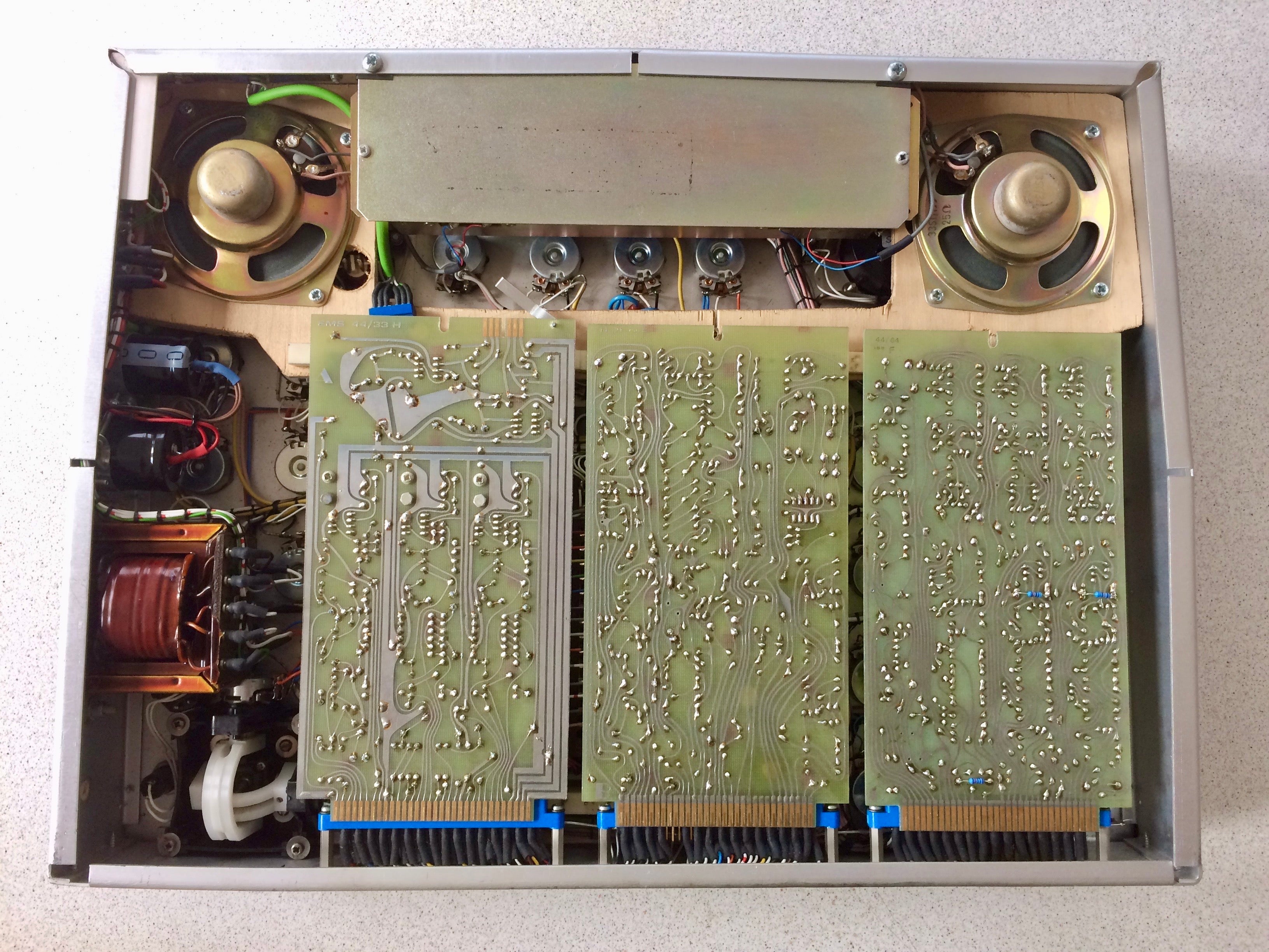 Electronic device with circuit boards and mechanical components on a gray background