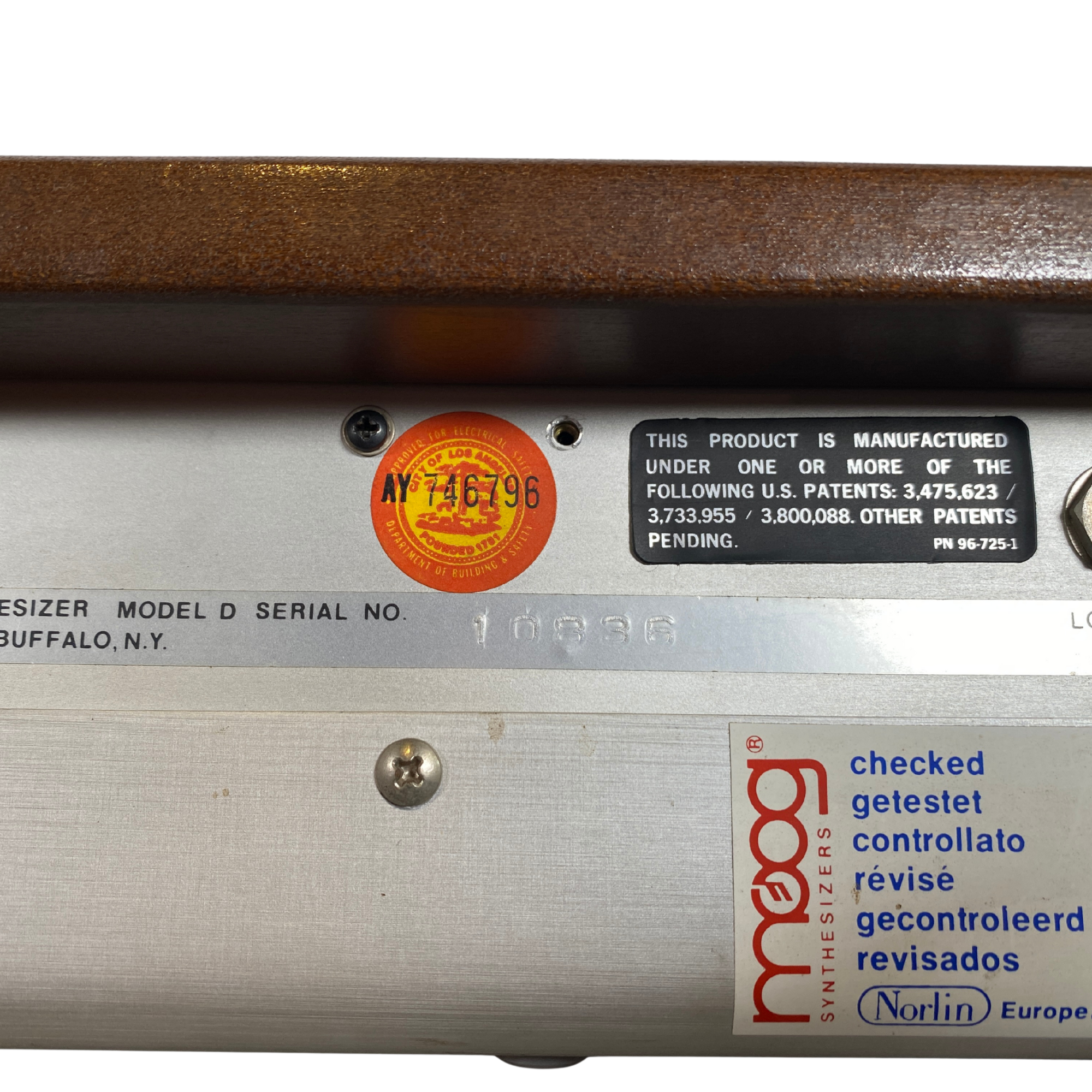 Close-up of a product label with branding and text on a metallic surface.