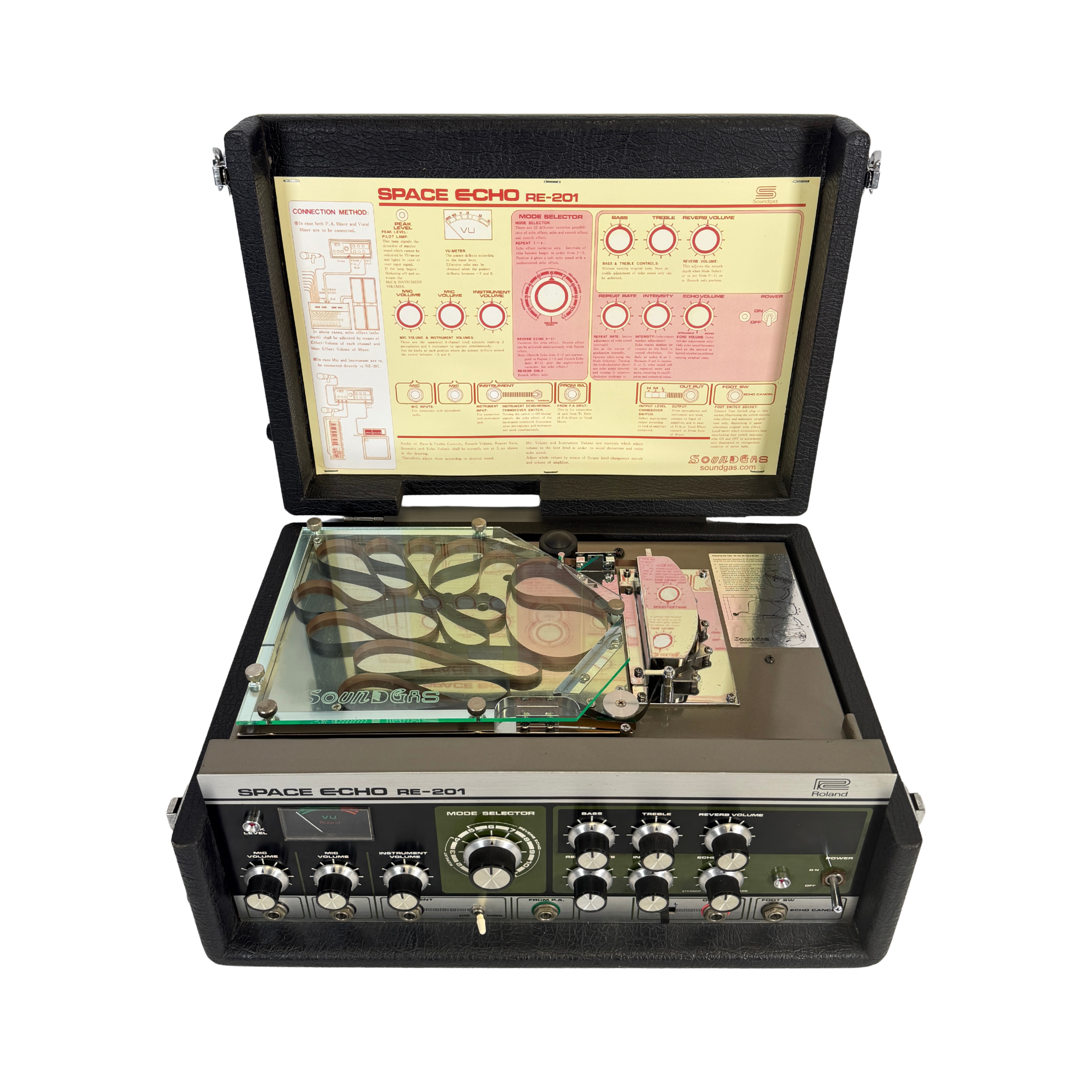 An open vintage Space Echo RS-201 portable recording device in its black carrying case, showing the internal tape deck, control knobs, and the instruction manual inside the lid.