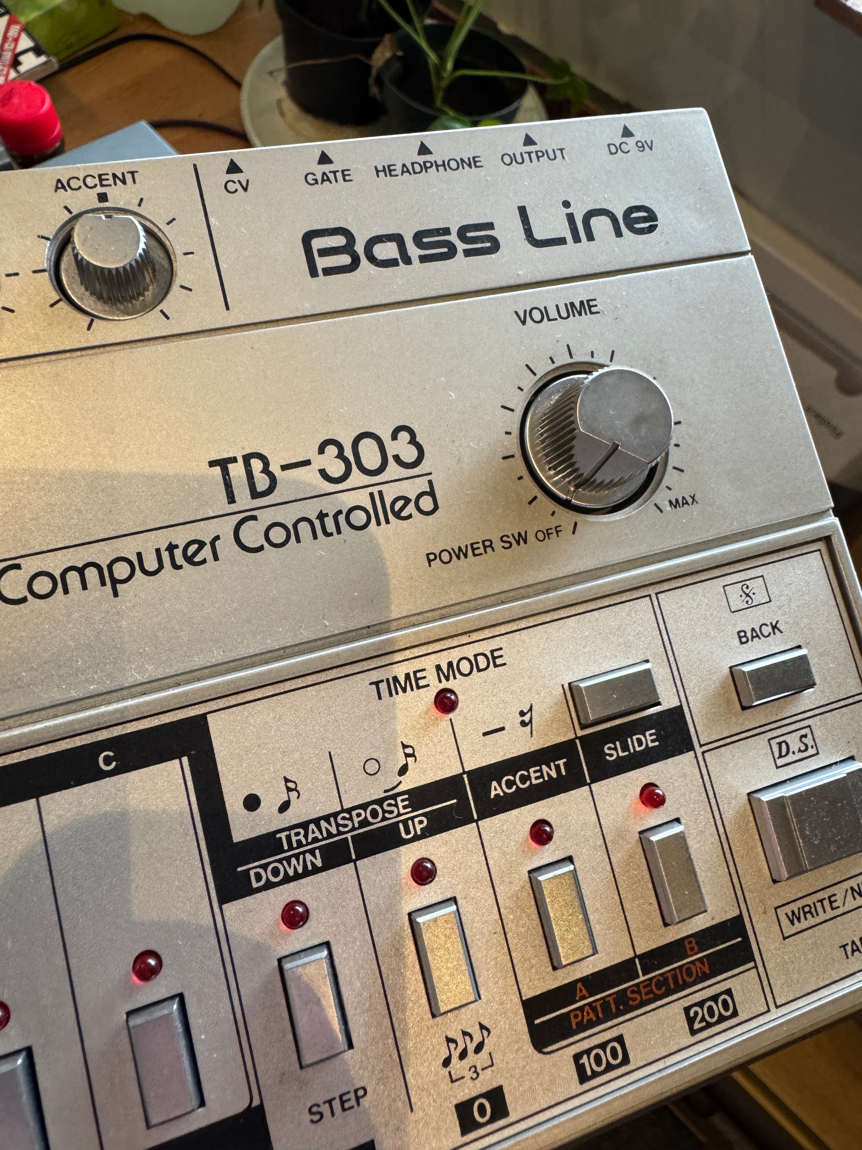 Bass Line TB-303 computer controlled synthesizer with visible branding.