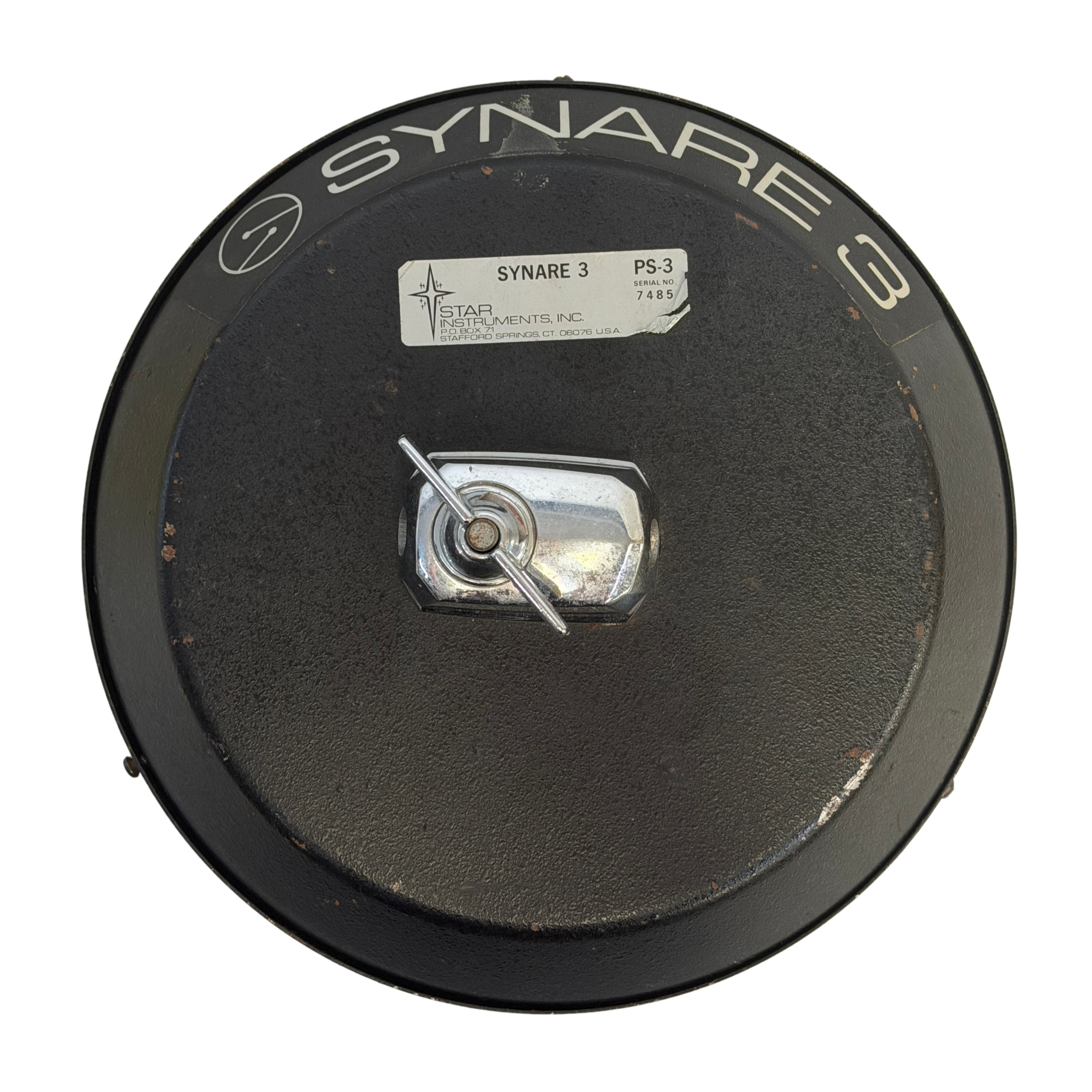 A circular black Synare 3 PS-3 electronic component cover by Star Instruments, featuring a central silver metal connector and white printed branding.