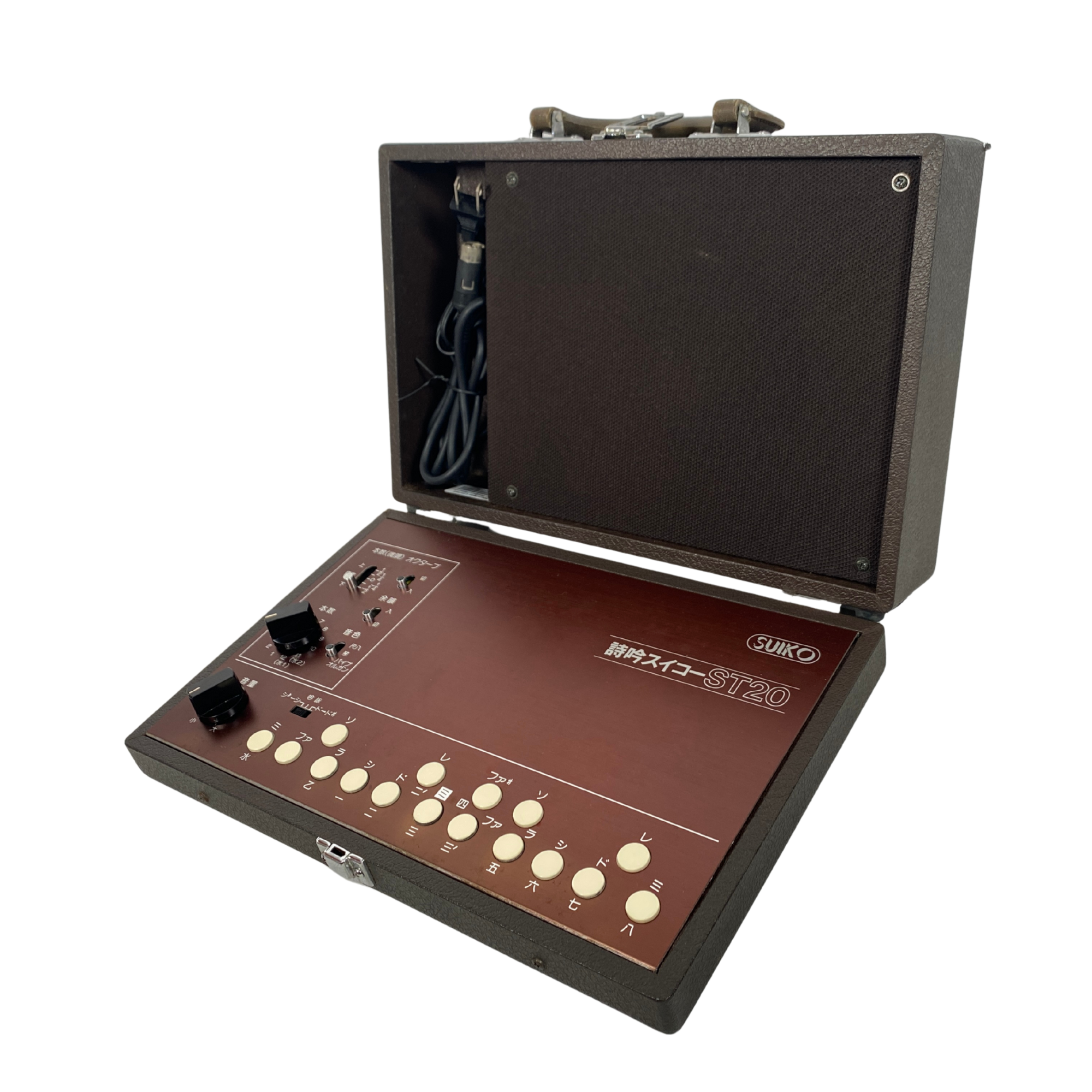 Vintage electronic device with buttons and a cable, branded 'Gakko', on a white background.