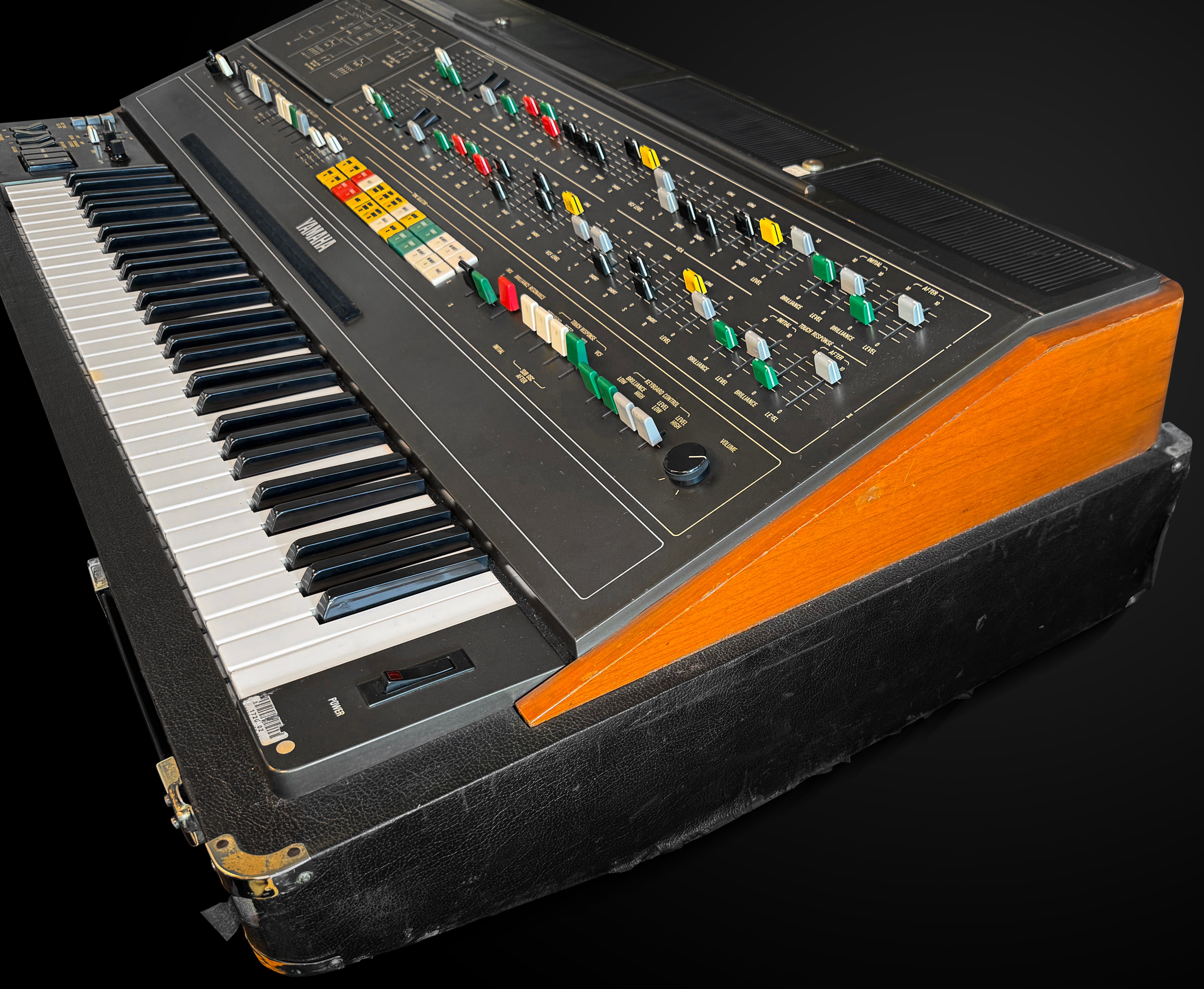 Vintage synthesizer with keyboard and control panel on a black background