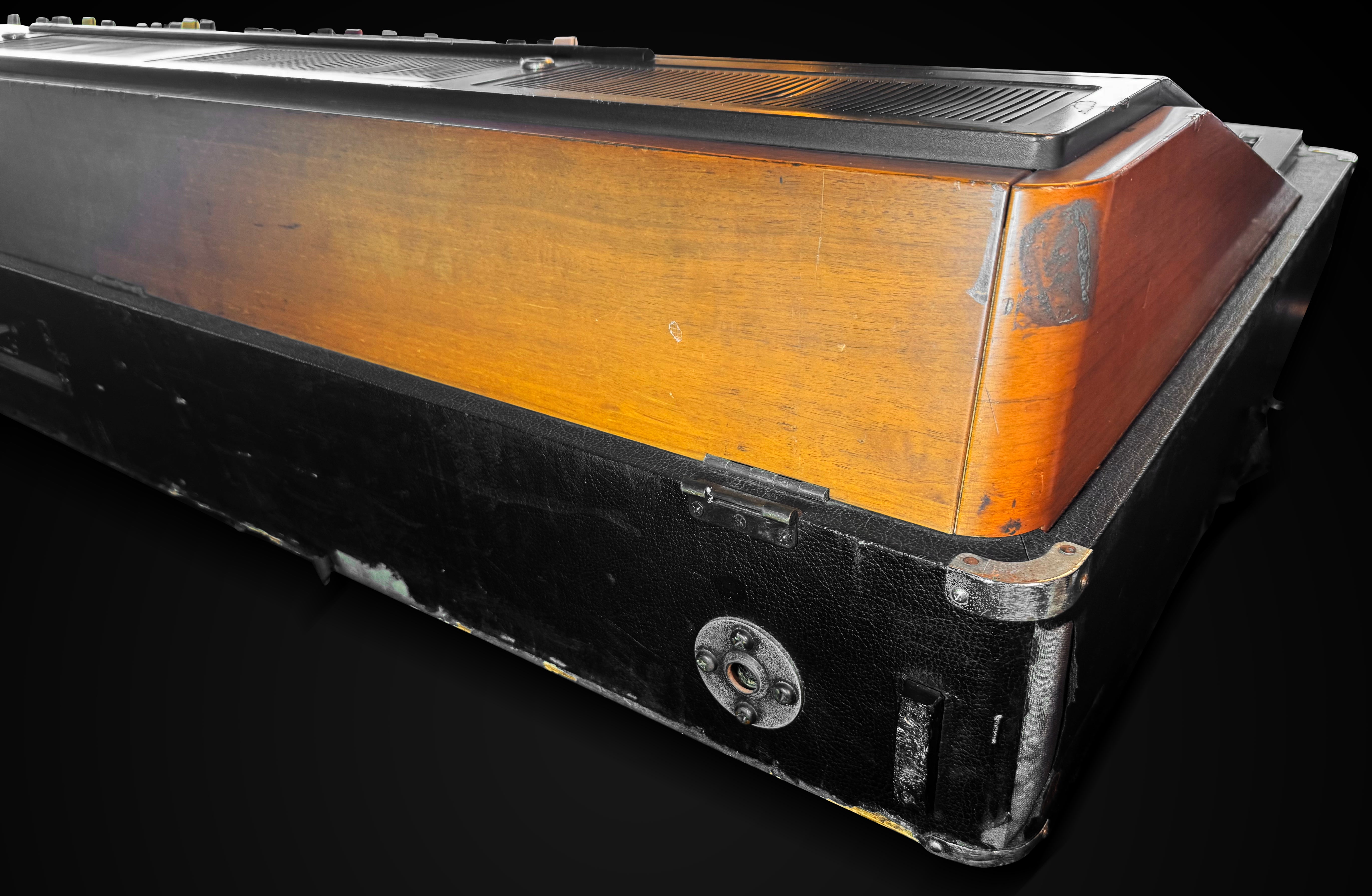 Vintage wooden object with black base on a dark background