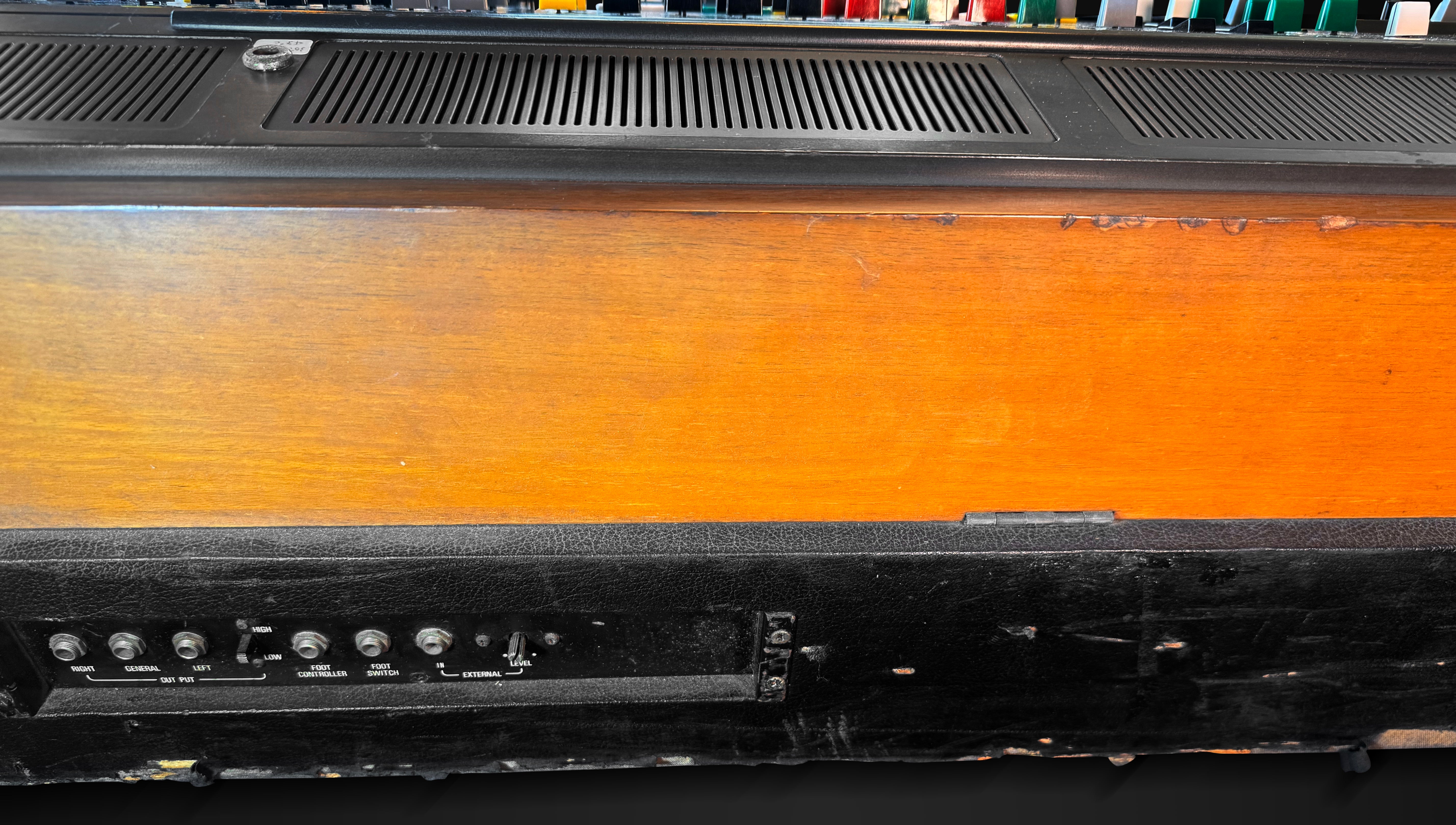Vintage electronic equipment with wooden panel and control knobs on a black background