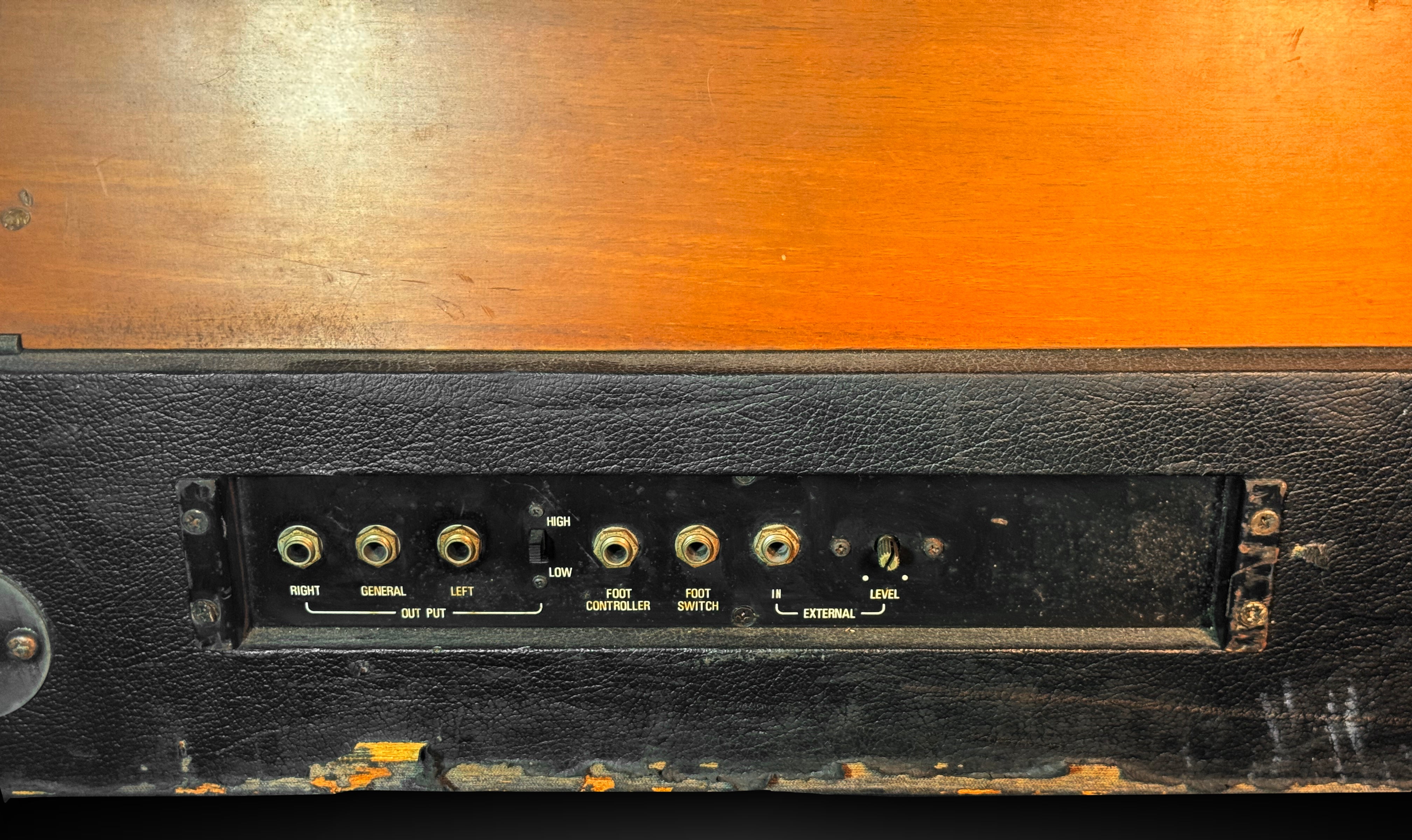 Vintage electronic device with control panel on a wooden surface
